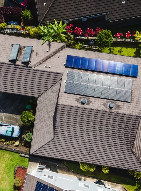 Aerial view of a finished rooftop solar system on an Oʻahu home